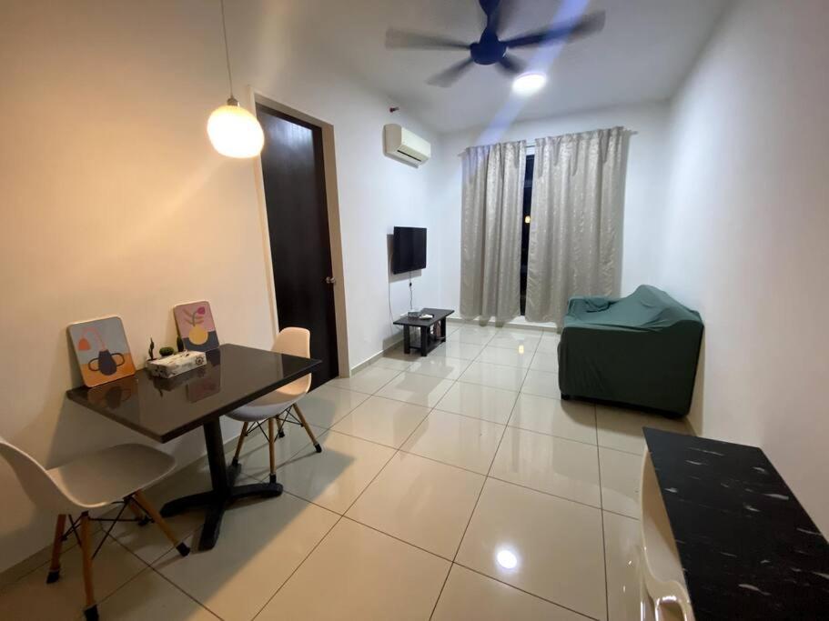 - un salon avec une table et un ventilateur de plafond dans l'établissement The Stay Guest House @ Kenwingston Residence, à Cyberjaya