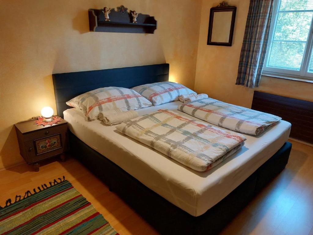 a bed with two pillows and a table in a bedroom at Ferienwohnung Heimberger in Purgstall