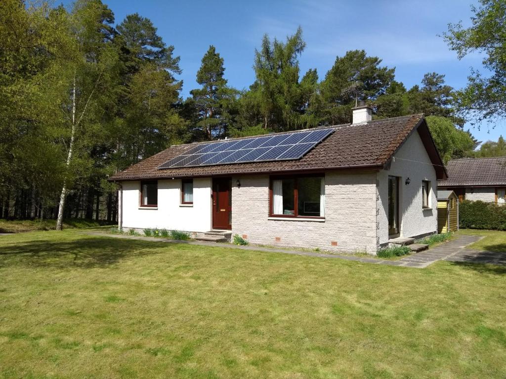 a house with solar panels on the roof at Aonach in Kingussie