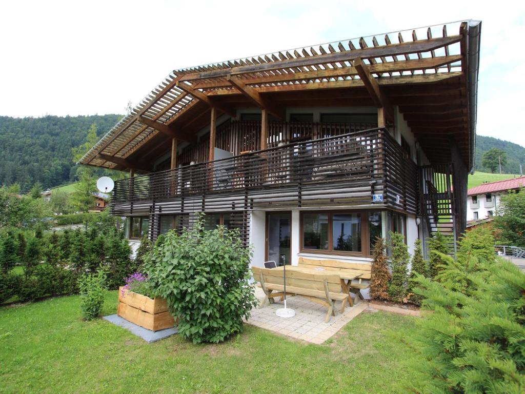 een huis met een bankje ervoor bij Modern Apartment in Kirchdorf with Garden in Kirchdorf in Tirol