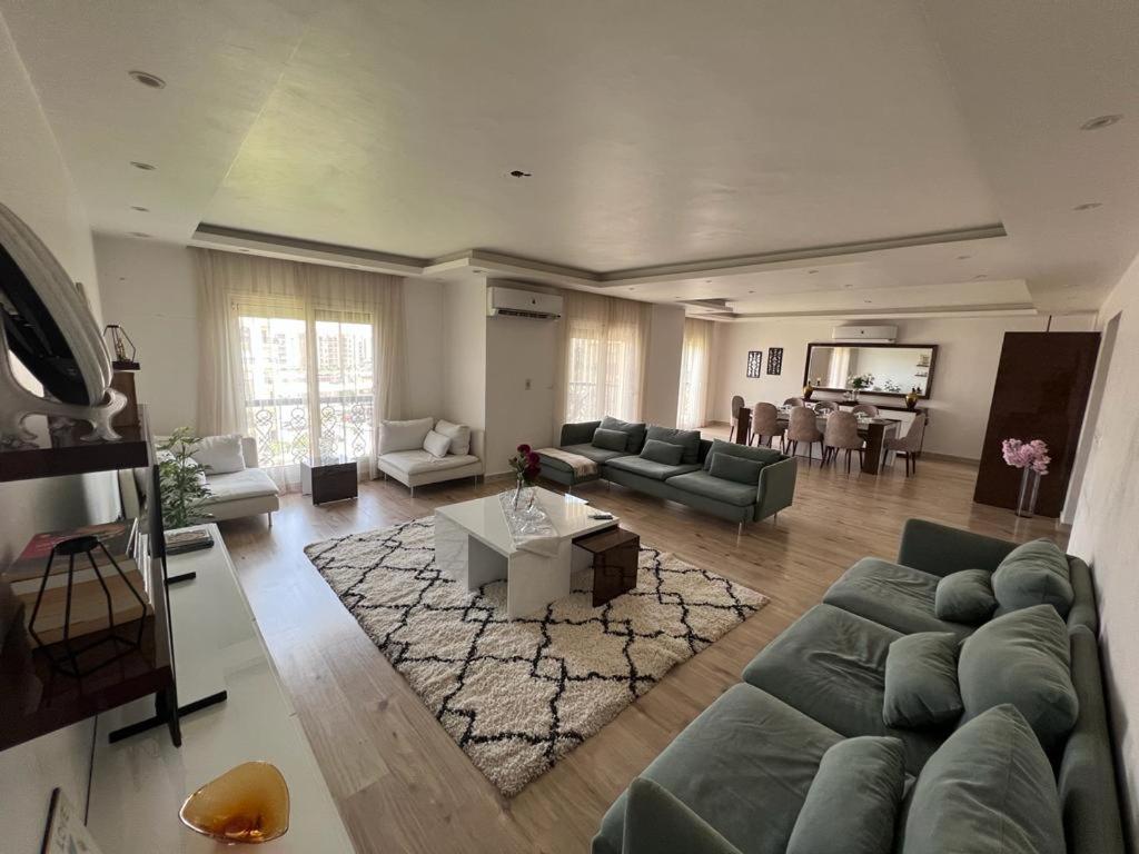 a large living room with a couch and a table at Al rehab city-new cairo in New cairo