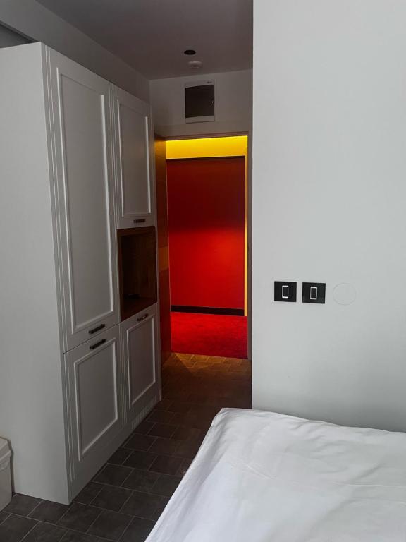 a bedroom with a bed and a red door at Vlasinsko jezero VILA BEST in Surdulica