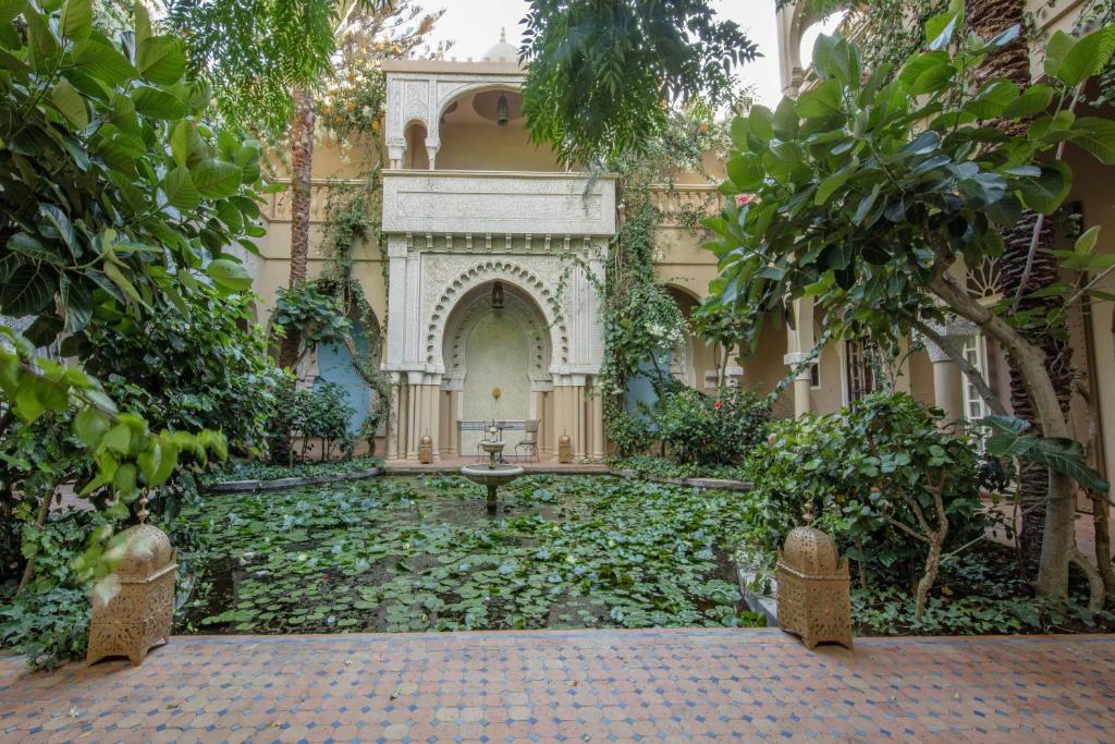 a courtyard of a building with a lot of plants at Riad Dar El Malaika in El Jadida