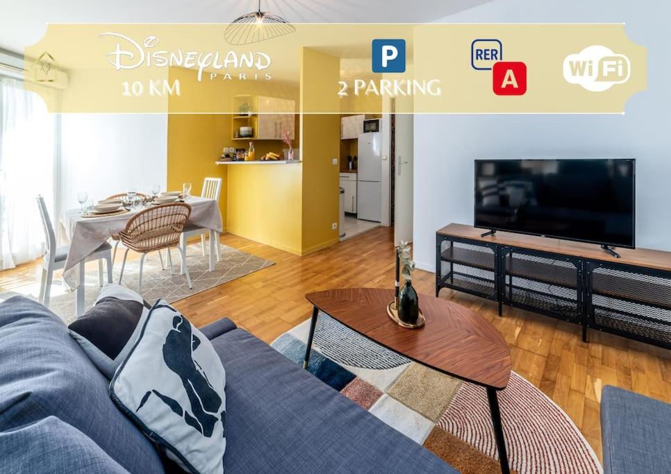 a living room with a couch and a tv and a table at Appartement near Disneyland Paris, 2 parking in Torcy