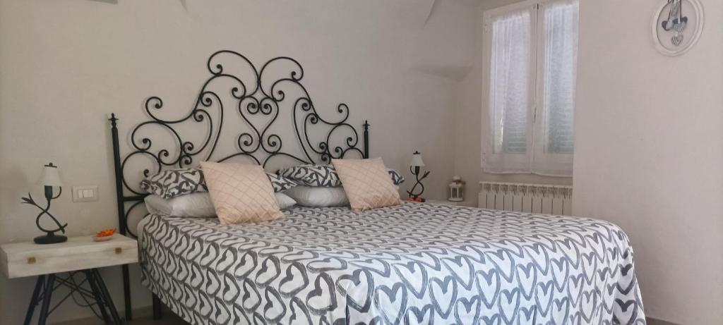 a bedroom with a black and white bed with pillows at Nene's Home in Sanremo