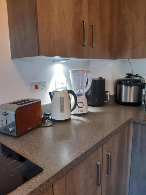 a kitchen counter with a toaster and a blender at Our Guests in Rushden