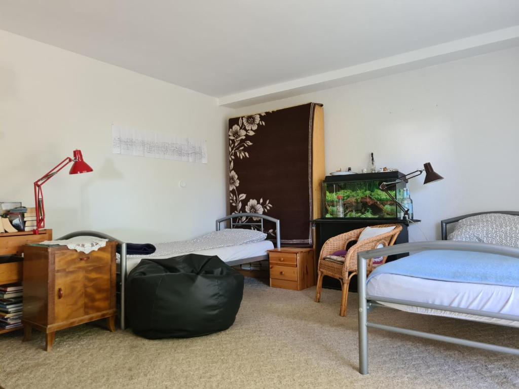 a bedroom with two beds and a fish tank at Eppstein in Eppstein