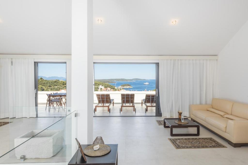 a living room with a couch and a view of the ocean at Maki Exclusive Apartments in Hvar