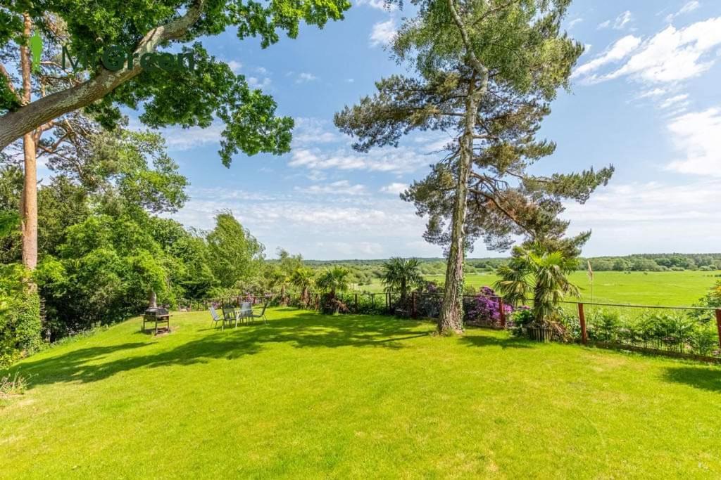 a large grassy yard with trees and benches at Guest suite Annex private room in Saint Ives