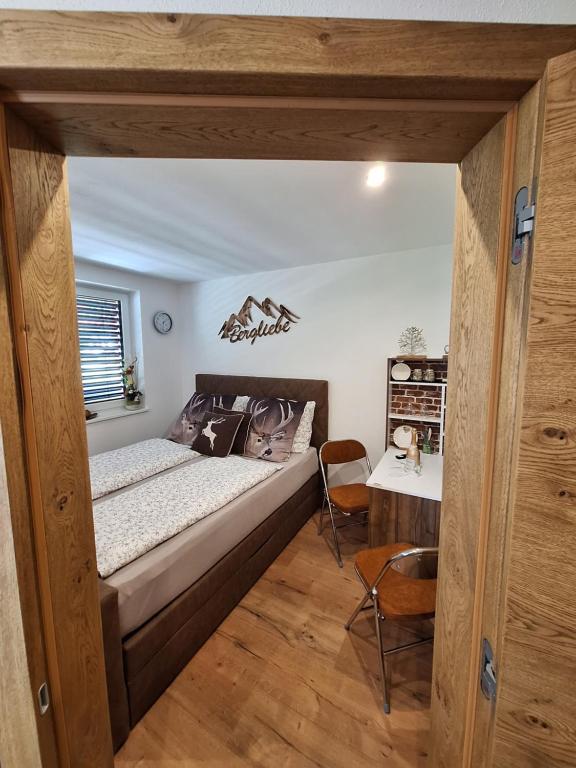 a bedroom with a large bed and a table at Bergliebe in Sankt Martin am Tennengebirge
