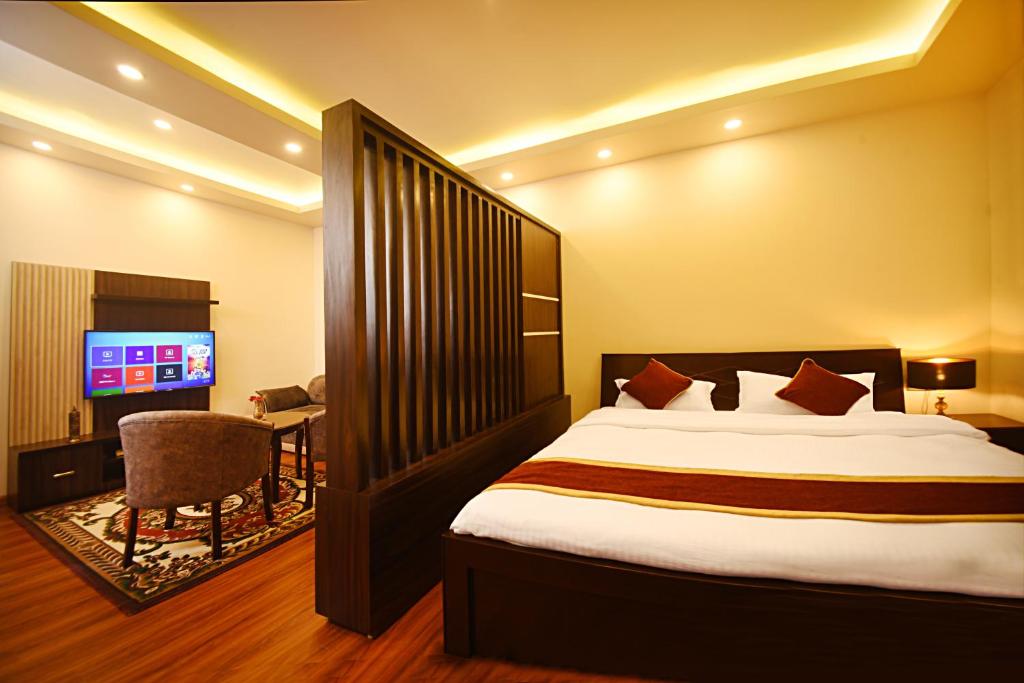 a hotel room with a bed and a television at Friends Apartment Pvt.Ltd in Kathmandu