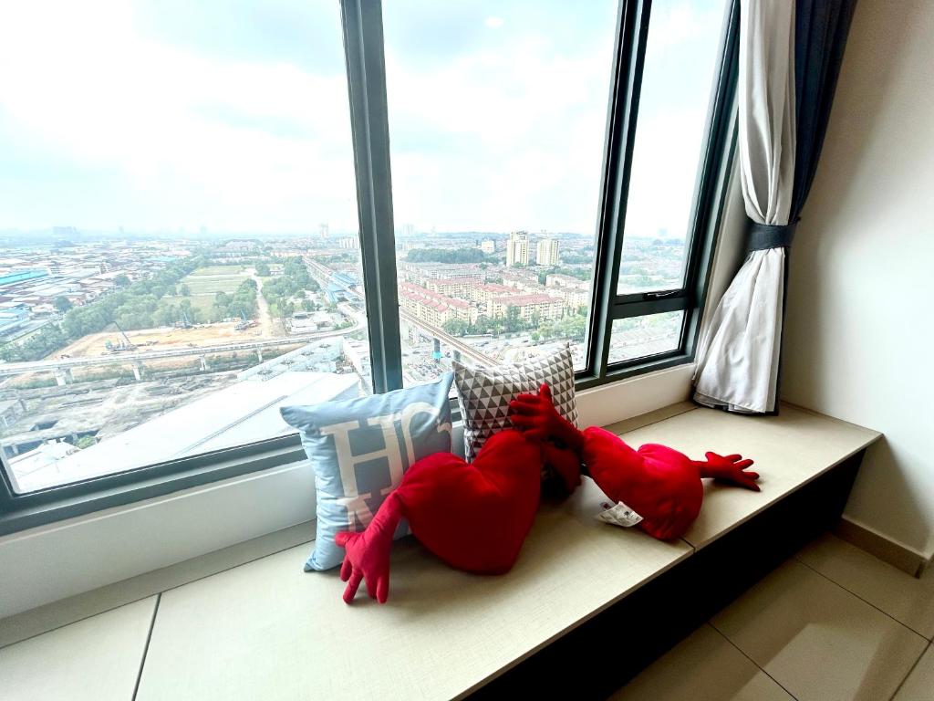 two stuffed animals are sitting on a window sill at Damen Suite (A) Sunway Subang by DW in Subang Jaya
