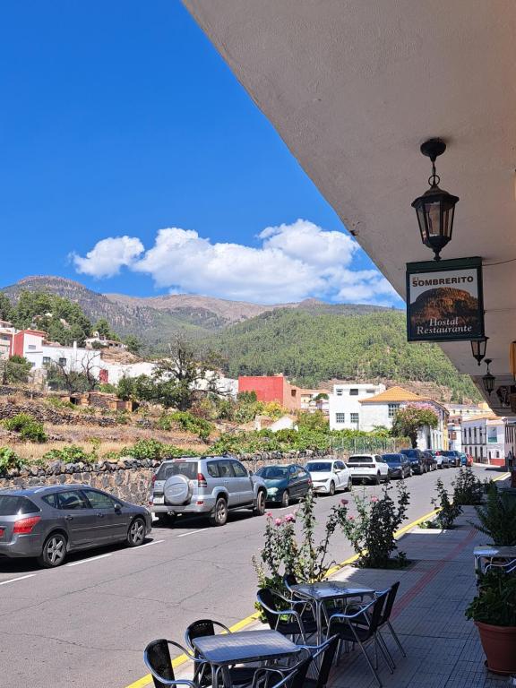 a street with cars parked on the side of the road at Hotel El Sombrerito in Vilaflor