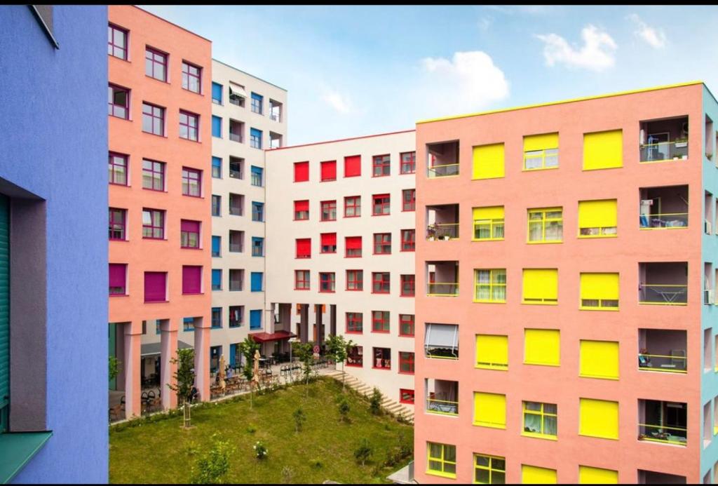 a group of tall buildings with colorful windows at Hejli's Apartment in Tirana