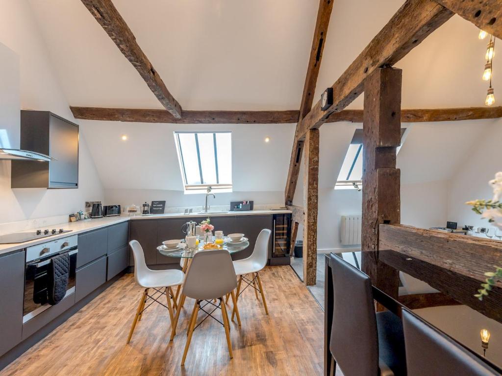 a kitchen and dining room with a table and chairs at Pass the Keys 5C Charming Town Centre Apartment With Roof Top Views in Shrewsbury