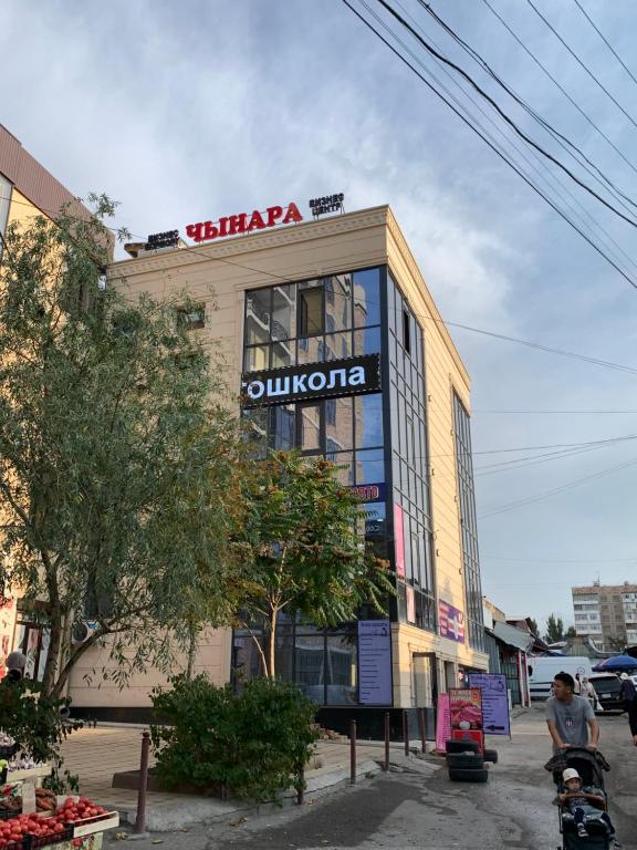 a building with a sign on the top of it at Hostel Orto Say in Bishkek