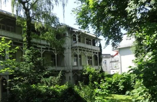 a large building with a porch on the side of it at Jugendstil Apartment in Bad Nauheim