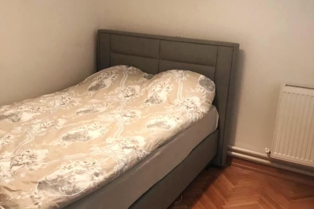an unmade bed in a small bedroom with a radiator at Comfortable accommodation and nearby attractions in Istanbul