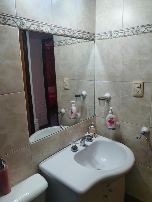 a bathroom with a sink and a mirror at Casa Familiar para hasta 6 personas , Lujan de Cuyo , Mendoza in Ciudad Lujan de Cuyo