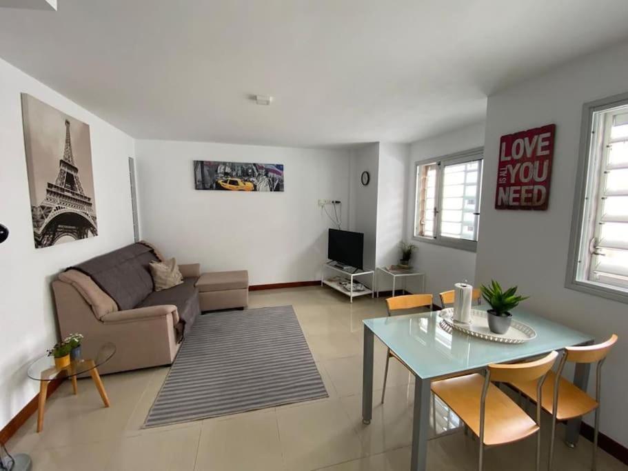 a living room with a couch and a table at Bright lovely quiet flat very centric in SC in Santa Cruz de Tenerife
