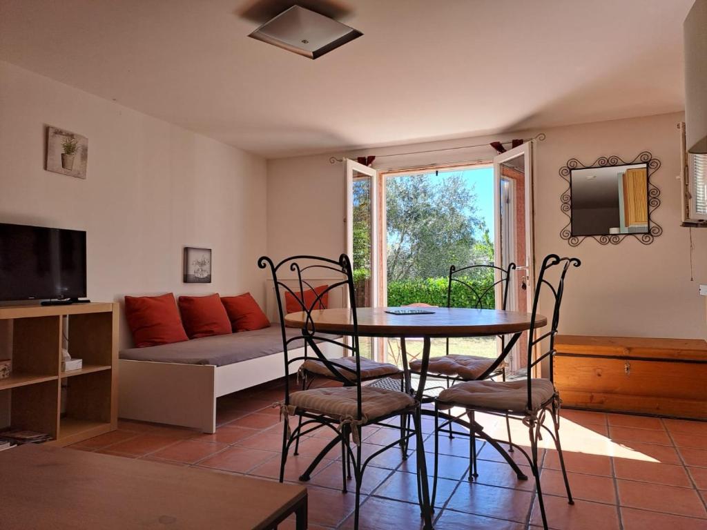 a living room with a table and chairs and a couch at Studio Escale champêtre 31 in Donneville