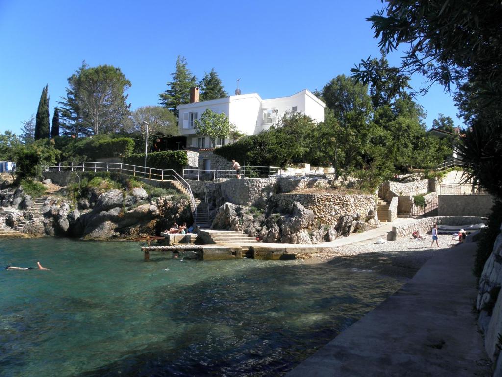 a group of people swimming in the water at Holiday Home Valica in Malinska