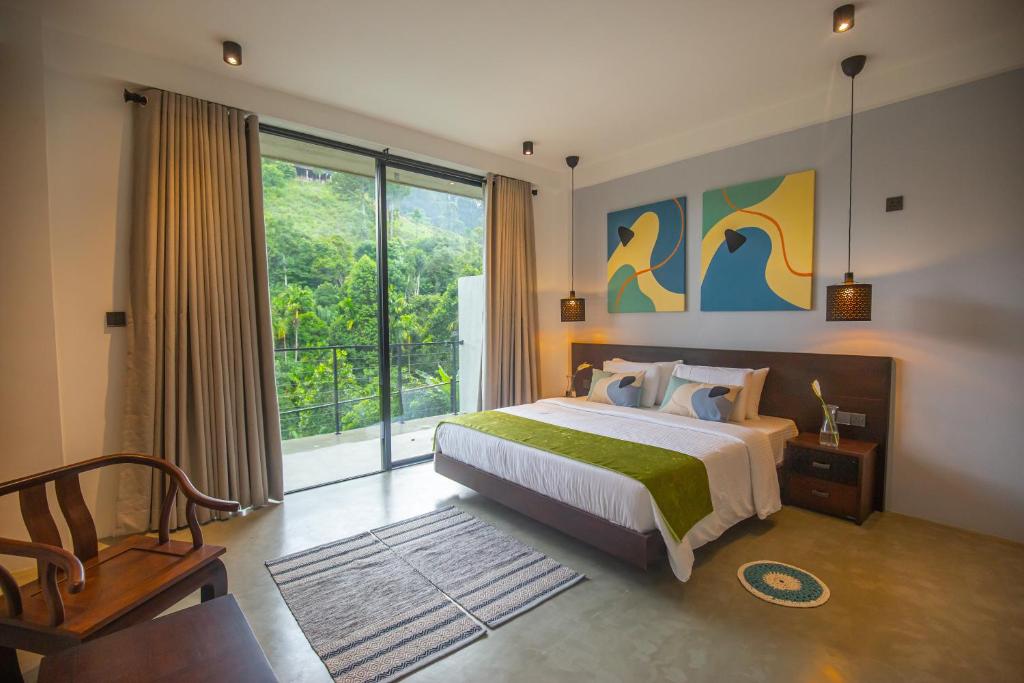 a bedroom with a bed and a large window at Namara Green Ella in Ella
