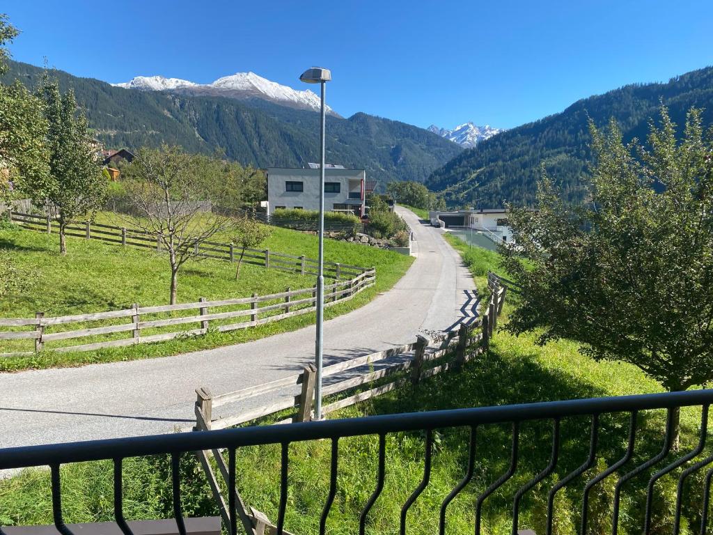 a view of a road with mountains in the background at Mountain Apartment in Alterzoll