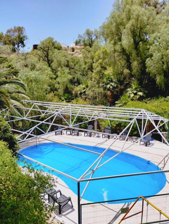 a swimming pool with a metal frame around it at Cabañas Pacari Tampu in Mendoza