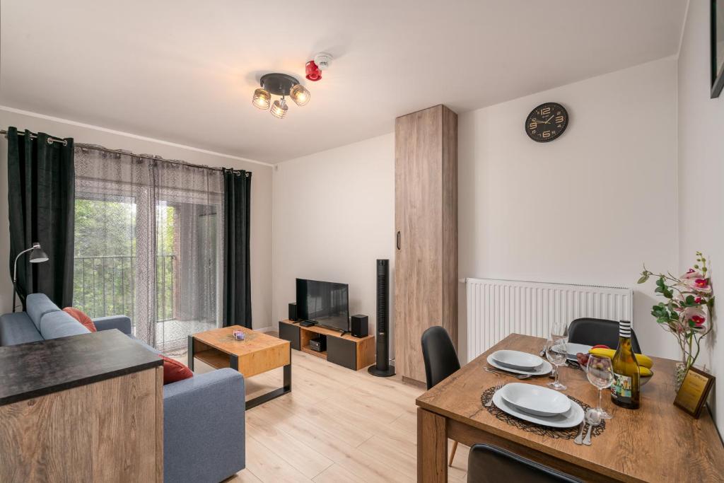 a living room with a table and a dining room at ApartWro 4th-City Square Railway Station balcony, garage, bicycles in Wrocław