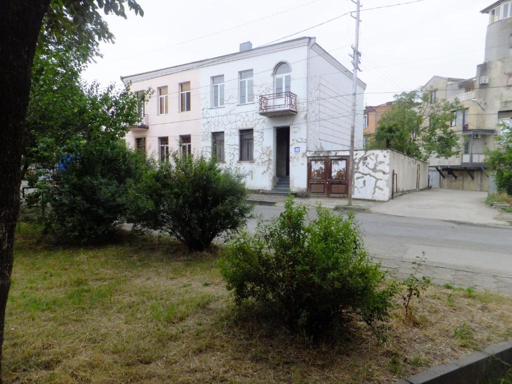 an old white building on the side of a street at Hostel Mana Kutaisi in Kutaisi