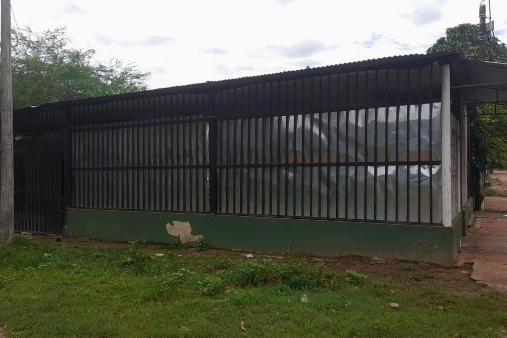 a black fence in a yard with grass at Home Puerto carreño vichada in Cerro el Bita