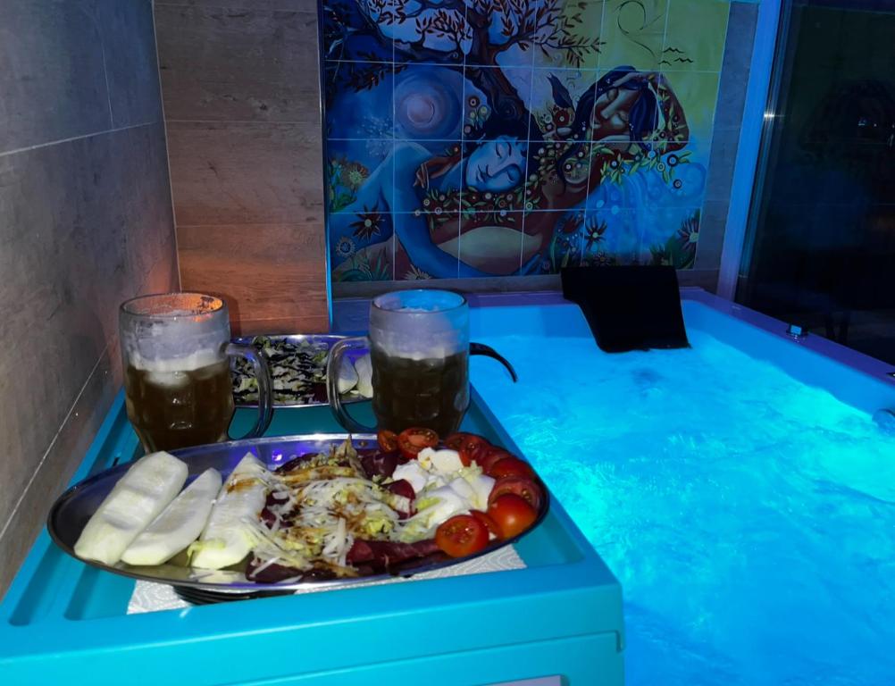 a plate of food on a table with two drinks at Casa Nunù in Taranto