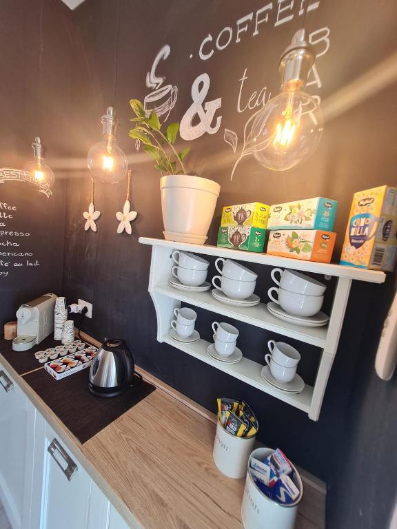 a kitchen counter with a shelf with pots and pans at Il Nido Casa indipendente a Fiumicino Self check in in Fiumicino