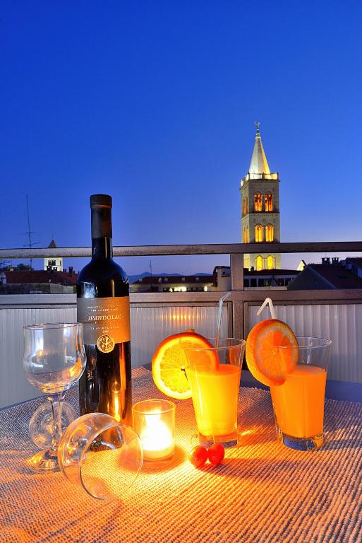 a bottle of wine and glasses on a table at Sea Gate Studio in Zadar