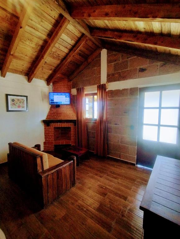 TV a/nebo společenská místnost v ubytování Cabañas el Corral del Rayo Huasca