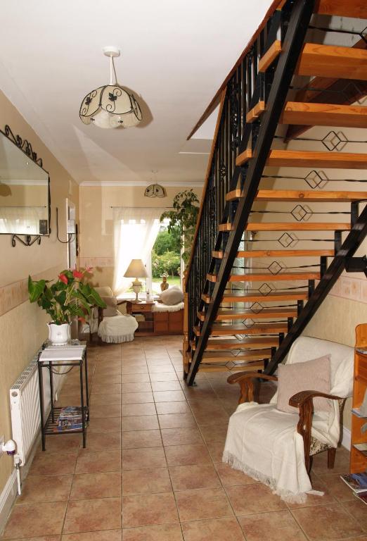 a hallway with a staircase and a living room at Killurin Lodge in Wexford