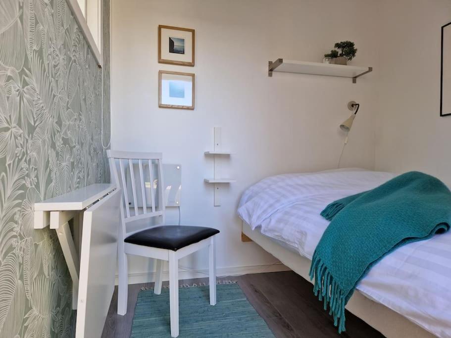 - une chambre avec un lit, une chaise et un bureau dans l'établissement Övernattningsrum i separat gästhus på Sävastön, à Boden