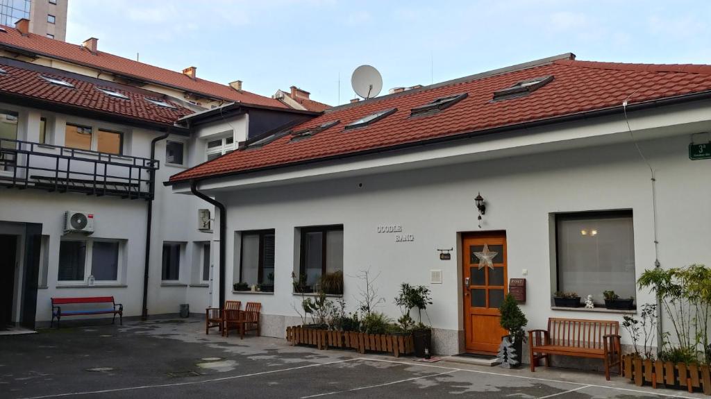 a white building with a red roof at Goodlebang, 3 bed room apartment, Center Ljubljana in Ljubljana
