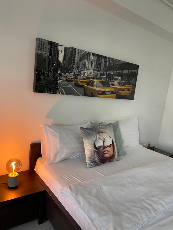 a picture of a woman with sunglasses on a bed at Welcome to Bucharest Airport Residences & Therme-SELF CHECK-IN in Otopeni