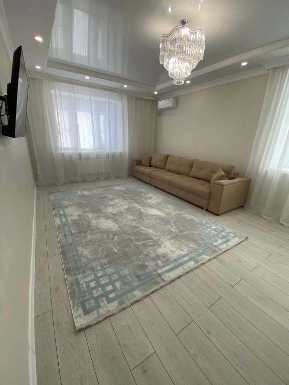 - un salon avec un canapé et un tapis dans l'établissement 2х комнатная квартира в элитном ЖК Альтаир в центре города, à Aqtöbe