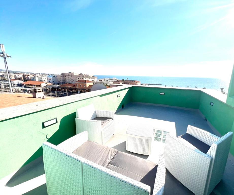 a balcony with chairs and a view of the ocean at Sealovers house with sea view & big terrace in Civitavecchia