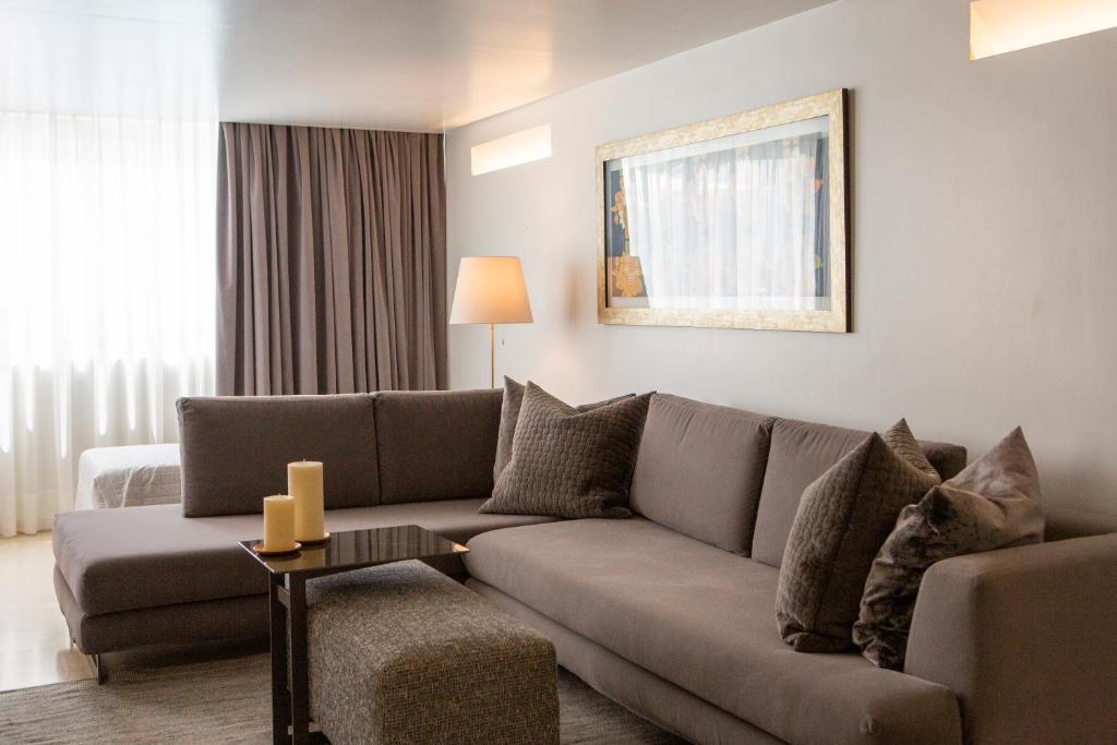 a living room with a couch and a table at Brasil Suites Boutique Hotel in Athens