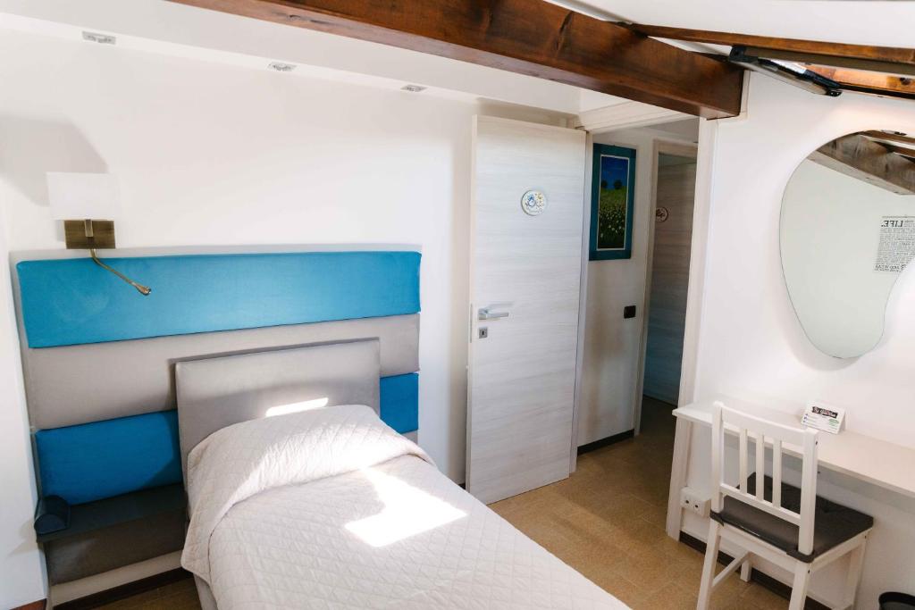 Łóżko lub łóżka w pokoju w obiekcie B&B Spina Verde