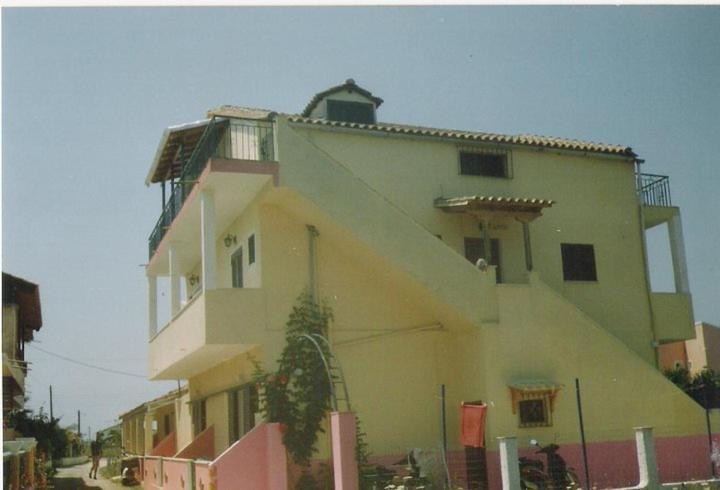 a large yellow building with at Adriana Saina Apartments in Agios Georgios