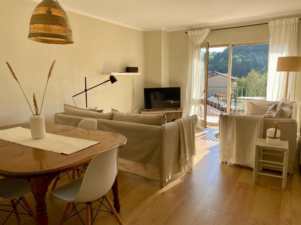 a living room with a couch and a table at Can Guasch in Camprodon