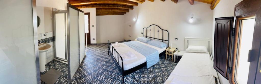 a bedroom with a bed and a bathroom at Corleone Bed in Corleone