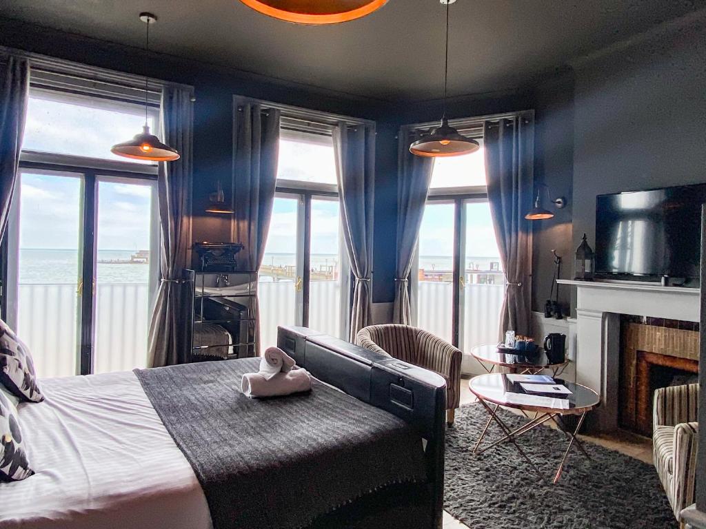 a bedroom with a bed with a view of the ocean at The Clarendon Hotel in Deal