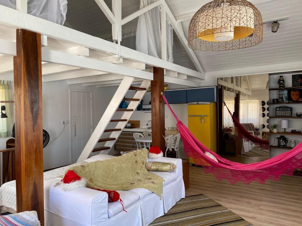 a living room with a hammock and a staircase at Casa América in Parnaíba