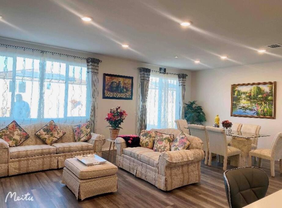 a living room with two couches and a dining room at One -Story House With 3 Rooms in Riverside